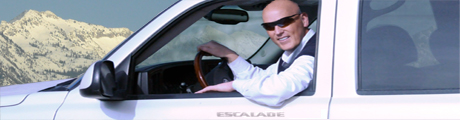 Smiling man with sunglasses in Escalade